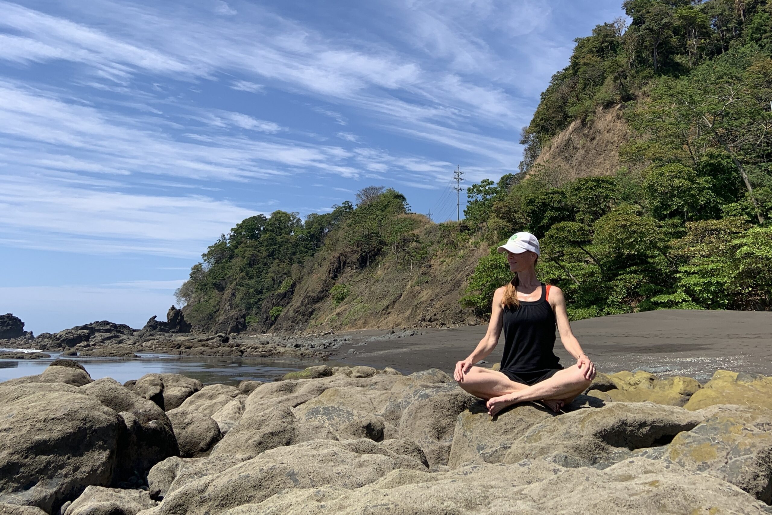 Jennifer sitting on the rocks at Playa Hermosa, Costa Rica