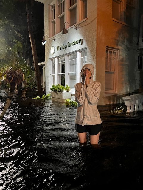 Jennifer French, Owner of The Yoga Sanctuary in Punta Gorda Florida standing in thigh deep water from storm surge of Hurricane Helene