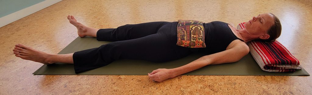 Jennifer French, E-RYT and owner of The Yoga Sanctuary in Downtown Punta Gorda, Florida demonstrating sandbag breathing